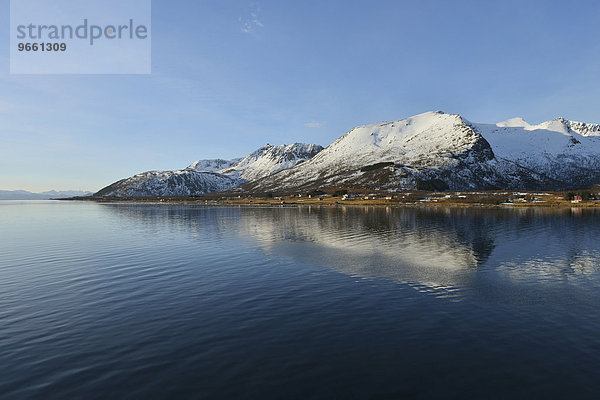 Schneebedeckte Berge der südlichen Insel Andøya spiegeln sich im Risøysund  Andøya  Vesterålen  Norwegen  Europa