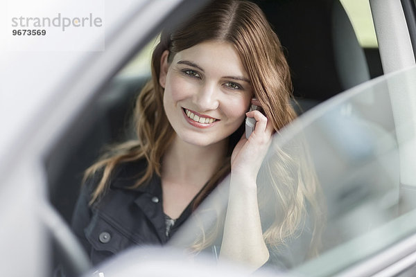 Frau lächeln Auto sprechen jung telefoniert
