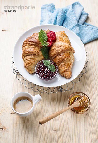 Croissants mit Himbeermarmelade  Honig und Kaffee