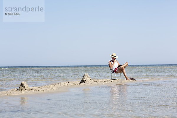 Mann Buch Strand reifer Erwachsene reife Erwachsene Taschenbuch vorlesen