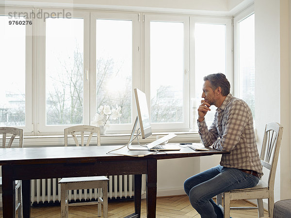 Germany  Cologne  Mature man working from home