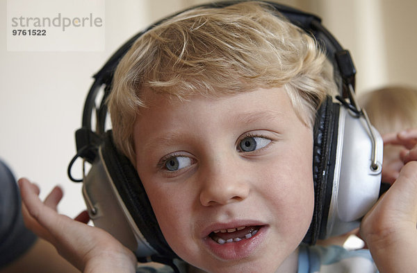 Kleiner Junge hört Musik mit Kopfhörer