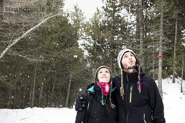 Lächelndes Paar im Wald im Winter