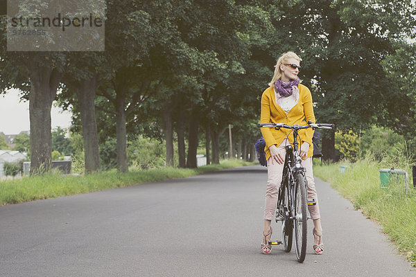 Deutschland  Düsseldorf  Frau auf dem Fahrrad