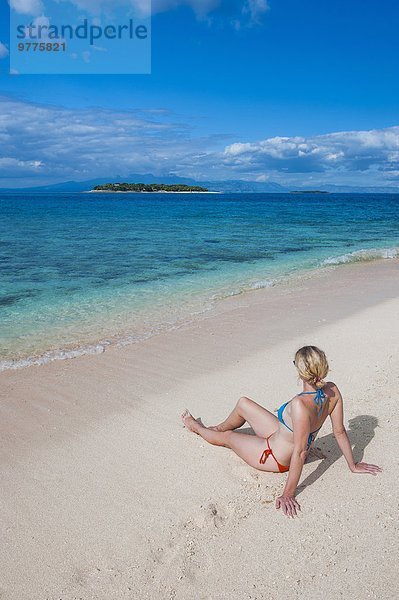 sitzend Frau Strand weiß Sand Insel Pazifischer Ozean Pazifik Stiller Ozean Großer Ozean Fiji