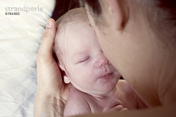 Mutterbindung mit Neugeborenem  über die Schulter gesehen
