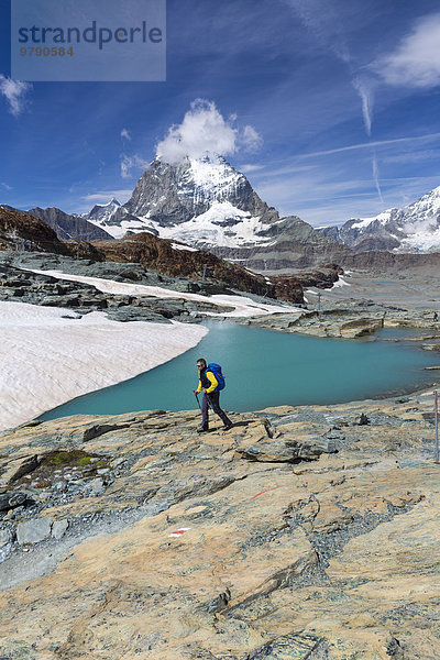 Wanderer an Gletschersee am Weg zur Gandegg Hütte  dahinter das Matterhorn  Gebiet Trockener Steg  Zermatt  Wallis  Schweiz  Europa