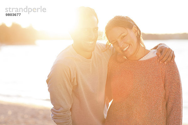 Porträt eines liebevollen Paares am Strand bei Sonnenuntergang