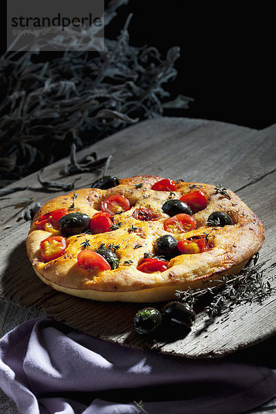 Foccaccia mit schwarzen Oliven  Tomaten und Oregano
