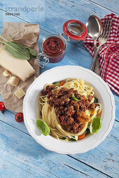 Teller mit Spaghetti Bolgnese und Zutaten