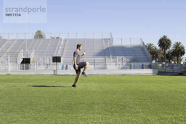 USA  Kalifornien  San Luis Obispo  junger Mann beim Training auf einem Sportplatz