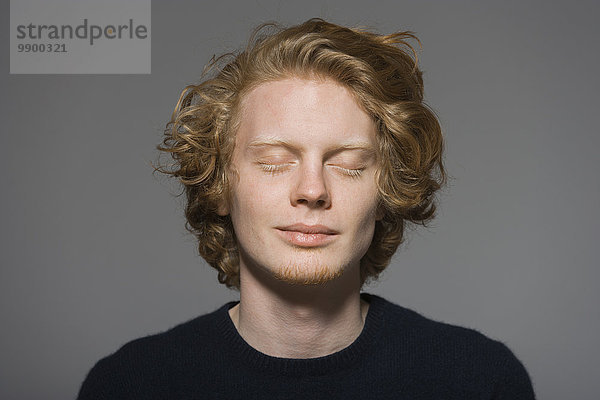 Porträt eines jungen Mannes mit geschlossenen Augen