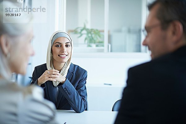 Über-Schulter-Ansicht einer jungen Geschäftsfrau beim Vorstellungsgespräch im Büro