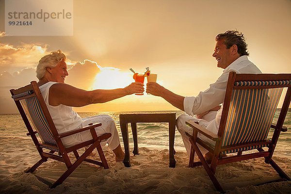 Seniorenpaar Toastgetränke am Strand  Malediven