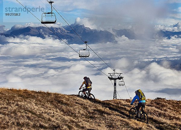 Zwei Mountainbiker unter den Seilbahnen  Wallis  Schweiz