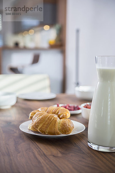 Croissants and milk for breakfast at dining table  Munich  Bavaria  Germany