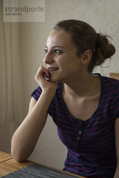 Teenage Girl day dreaming with her hand on chin  Bavaria  Germany