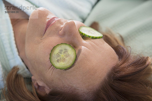 Senior woman with cucumber slices on her eyes  Munich  Bavaria  Germany