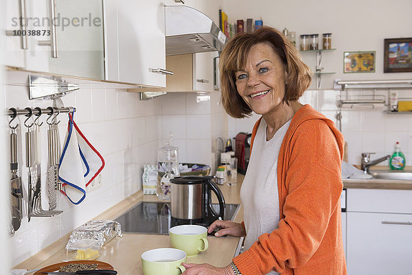 Senior woman preparing tea in the kitchen  Munich  Bavaria  Germany