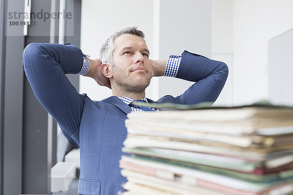 Businessman relaxing in office  Leipzig  Saxony  Germany