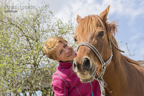 Woman showing affection to her horse  Bavaria  Germany