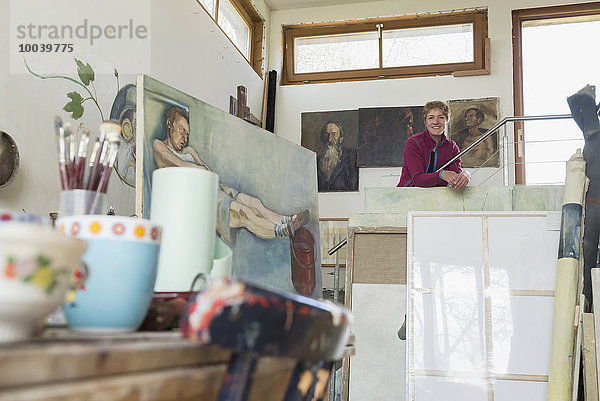 Portrait of a female artist smiling in her studio  Bavaria  Germany