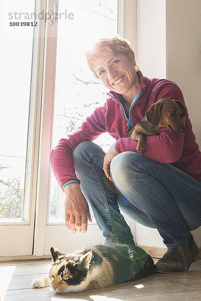 Mature woman with her pets at home  Bavaria  Germany