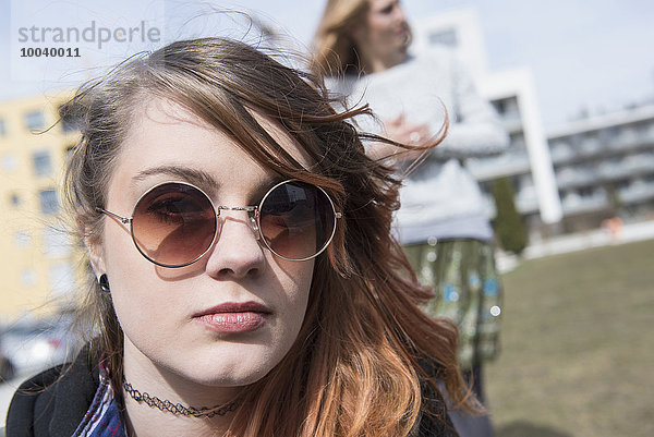Portrait of a young woman wearing sunglasses  Munich  Bavaria  Germany