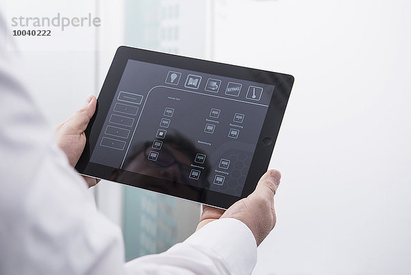 Man operating digital tablet in office  Munich  Bavaria  Germany