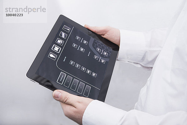 Man operating digital tablet in office  Munich  Bavaria  Germany