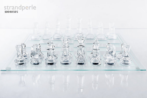 Glass chess pieces on board  Bavaria  Germany