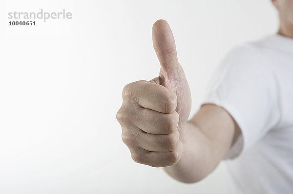 Close-up of a man's hand giving thumbs up  Bavaria  Germany