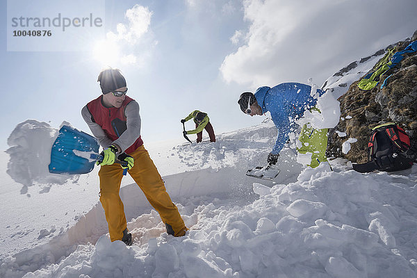 Men shovelling snow for bivouac camp  Tyrol  Austria