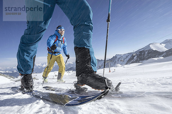 Ski mountaineers climbing on snowy mountain in snow storm  Zell Am See  Austria