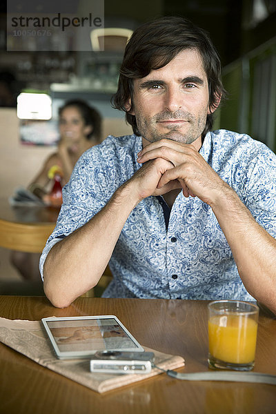 Porträt eines Mannes  der in einem Café wartet.