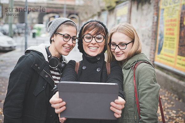 Drei Schwestern  die ein Selfie auf der Straße aufnehmen