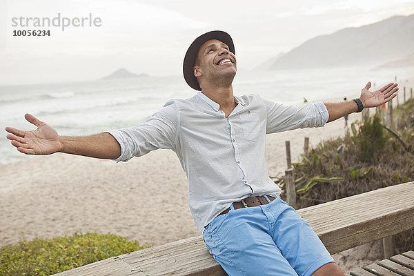Mittlerer Erwachsener Mann auf einem Zaun mit offenen Armen  Rio De Janeiro  Brasilien