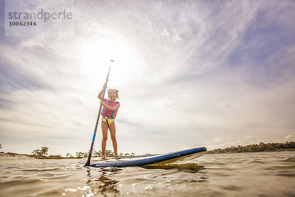 Girl standup paddleboarding im Sound  Fort Walton  Florida  USA