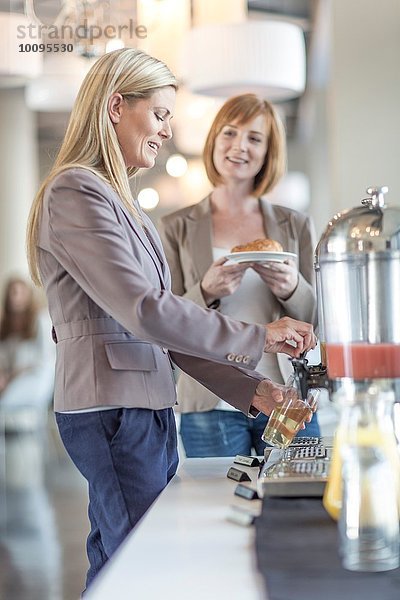 Zwei Geschäftsfrauen beim Frühstück im Hotelrestaurant