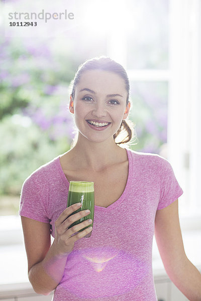 Portrait Frau lächeln grün trinken smoothie