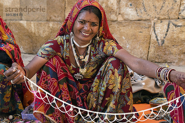 Verkäuferin mit buntem Sari  Souvenir für Touristen  Jaisalmer  Rajasthan  Indien  Asien