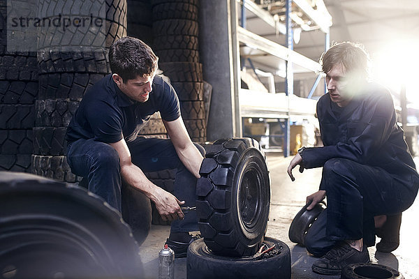 Mechaniker reparieren Reifen in der Kfz-Werkstatt