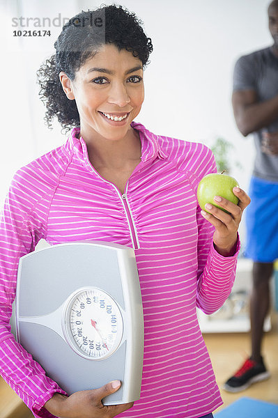 Waage - Messgerät Fitness-Studio Frau halten Apfel