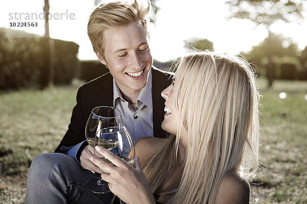 Elegantes junges Paar im Freien beim Weintrinken