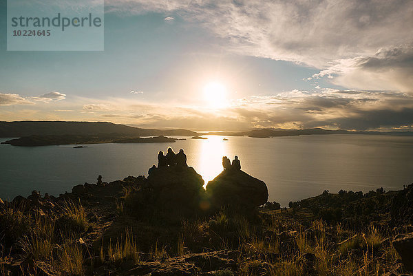 Peru  Menschen beobachten den Sonnenuntergang am Titicacasee