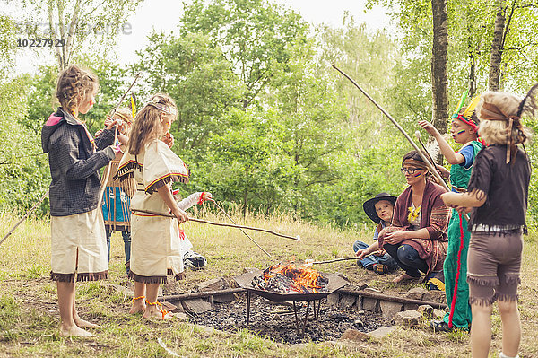 Deutschland  Sachsen  Indianer- und Cowboy-Party  Kinder rastende Marshmallows am Stiel