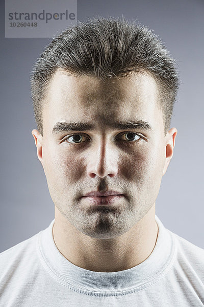 Porträt eines hübschen jungen Mannes über grauem Hintergrund