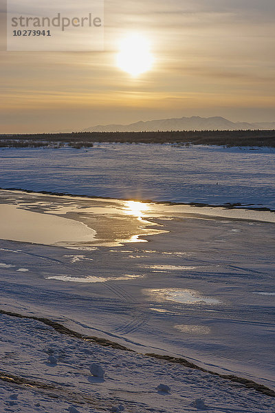 Ufer des zugefrorenen Noatak River bei Sonnenuntergang im Winter; Noatak  Alaska  Vereinigte Staaten von Amerika'.
