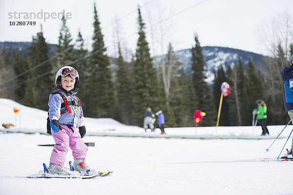 Kleines Mädchen (2-3) lernt Skifahren