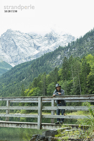 Tourist steht auf dem Steg am Eibsee  Bayern  Deutschland